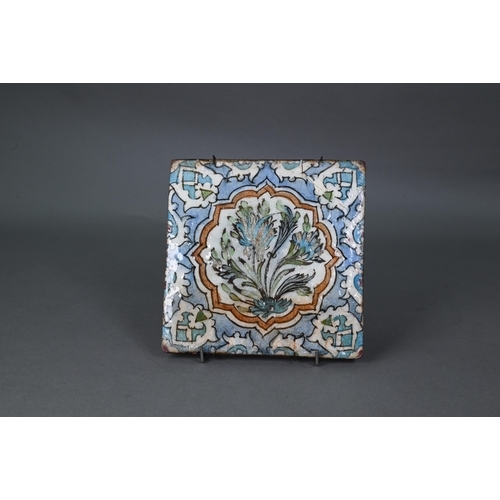 497 - An Ottoman Iznik fritware tile, painted with Islamic floral designs in polychrome enamels under the ... 