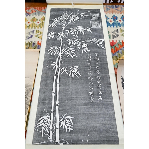 505 - A Singaporean traditional hand scroll painting, ink and colour on silk with a figure walking through... 