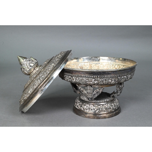 508 - A South East Asian silver stem bowl and cover with lotus bud finial, profusely embossed and engraved... 