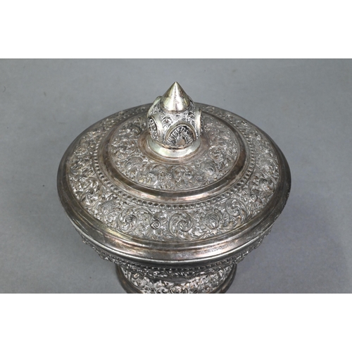 508 - A South East Asian silver stem bowl and cover with lotus bud finial, profusely embossed and engraved... 