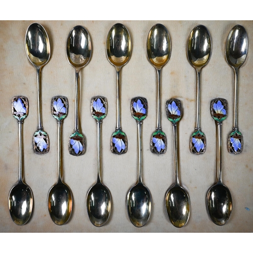 68 - Cased set of twelve Art Deco silver gilt coffee spoons with finials pierced and enamelled with butte... 