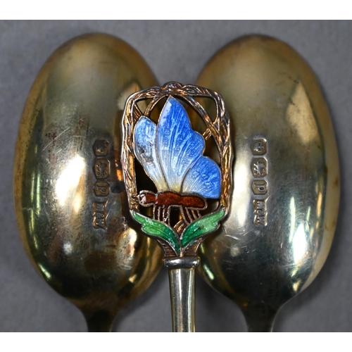 68 - Cased set of twelve Art Deco silver gilt coffee spoons with finials pierced and enamelled with butte... 