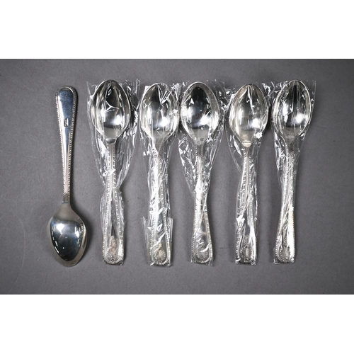 69 - Twelve coffee spoons with shell finials and feather-edge stems, stamped 'Silver' - unused in case fo... 