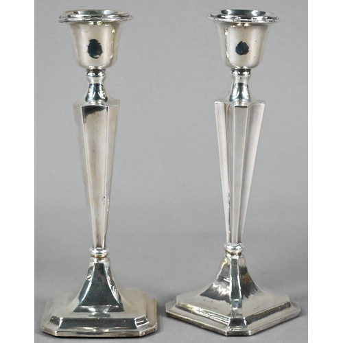 96 - Pair of loaded silver baluster candlesticks in the Art Deco style, on moulded square bases with cant... 