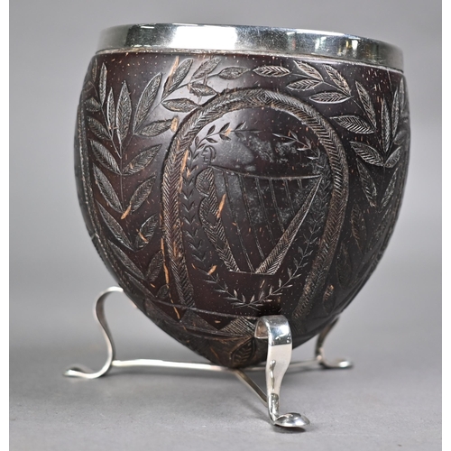 1184 - An 18th century coconut cup with later ep rim and feet, carved with Crown, Roses, Thistles and Harp,... 