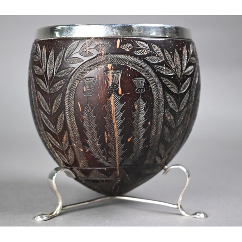 1184 - An 18th century coconut cup with later ep rim and feet, carved with Crown, Roses, Thistles and Harp,... 