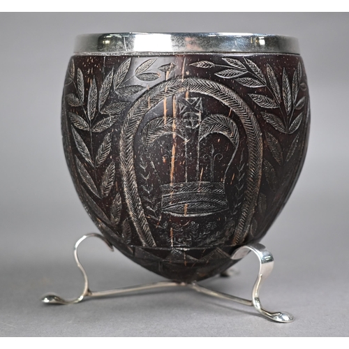 1184 - An 18th century coconut cup with later ep rim and feet, carved with Crown, Roses, Thistles and Harp,... 