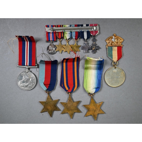 1194 - A Royal Navy miniature GRVI Distinguished Service Cross medal group comprising an MBE, DSC, 1939-45 ... 