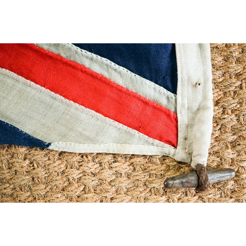 1199 - A WWII period Royal Navy ensign, of stitched panels with 'union jack' to top corner, stencilled 'C W... 