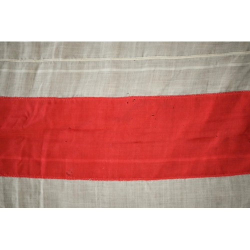 1199 - A WWII period Royal Navy ensign, of stitched panels with 'union jack' to top corner, stencilled 'C W... 