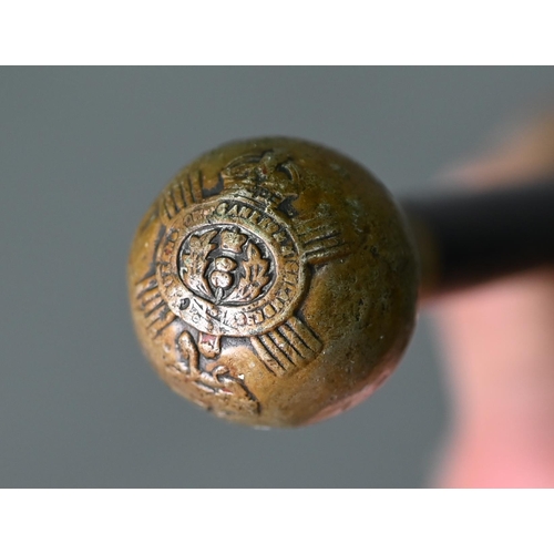 1217 - Antique ebonised military swagger-stick, the metal pommel embossed with regimental badge - Queen's O... 