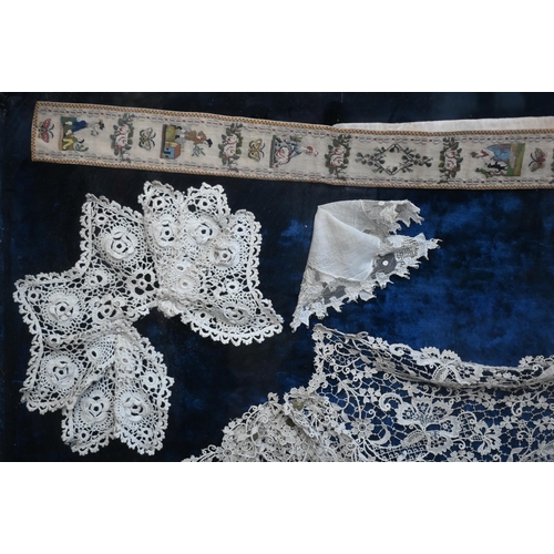 1284 - A framed collection of antique lace fringings, trimmings, collars, lace-edged handkerchief, and a ne... 