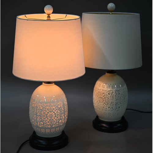 1290 - A pair of reticulated Chinese blanc de chine style table lamps by Orchid, with twin illumination and... 