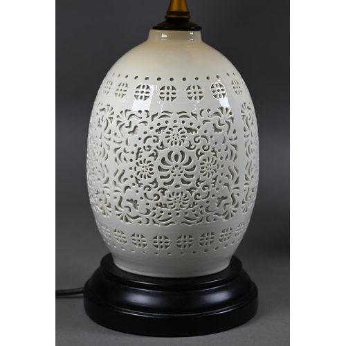 1290 - A pair of reticulated Chinese blanc de chine style table lamps by Orchid, with twin illumination and... 