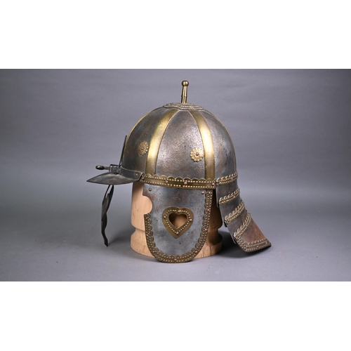 1296 - A 19th century Polish Hussars helmet, of rivetted and screwed form, on wood mount for display