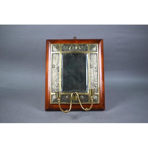 1298 - An Arts & Crafts brass twin girandole mounted mirror, the bevelled plate within intricate relief... 