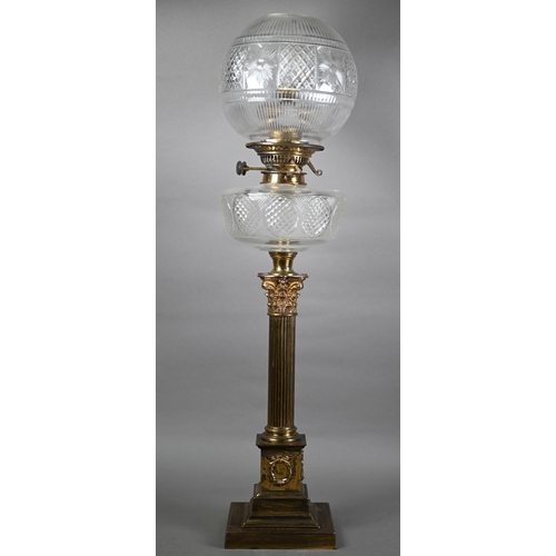 1300 - A late 19th century brass Corinthian column style cast oil lamp with clear cut-glass reservoir and s... 