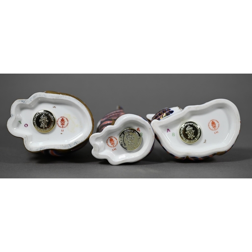 565 - Three Royal Crown Derby china cat paperweights, 13-4 cm to/w a miniature teapot (4)