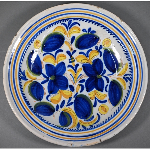 586 - Two Delft polychrome floral-design chargers and a blue and white example (two signed with initials R... 