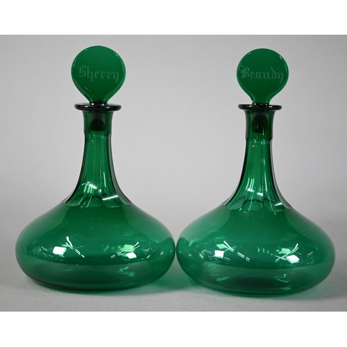 621 - Pair of Victorian green glass ship's decanters, the flattened stoppers, engraved for Brandy and Sher... 