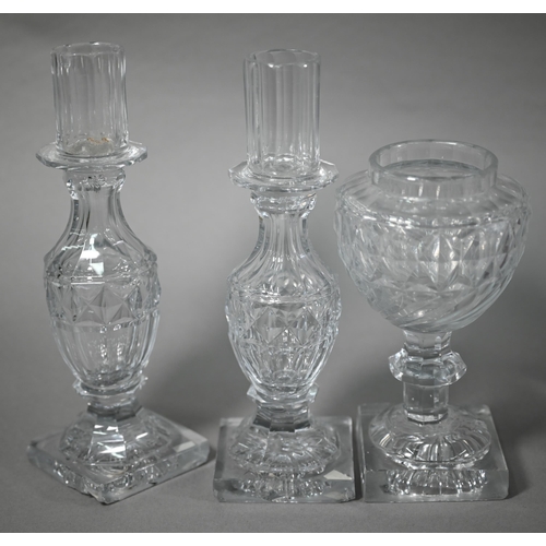 624 - Early 19th century cut and moulded glass three piece garniture comprising an urn flanked by two cand... 