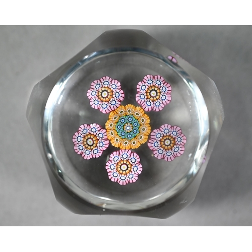 628 - Facetted glass pentagonal paperweight with floral canes and star-cut base, 6 cm diam to/w a Cornish ... 