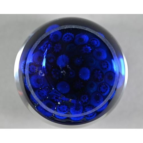 629 - Clichy glass floral cane weight on a blue ground, 7.2 cm diam