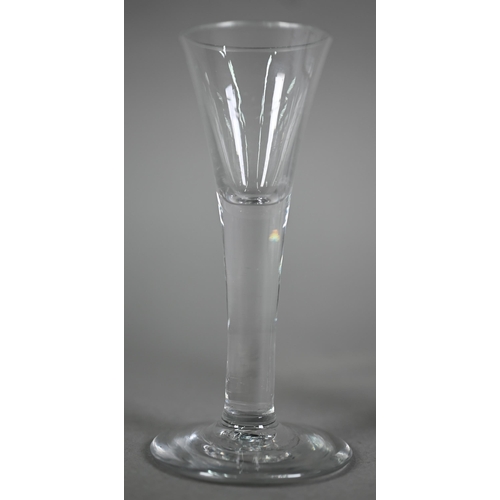 635 - A Georgian fluted jelly glass with flared rim and scroll handle, on ogee goot, 11.5 cm to/w a cordia... 