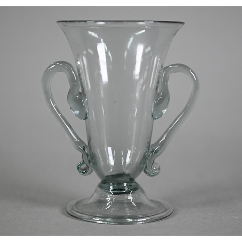 639 - A Georgian smoky jelly glass with twin scroll handles, on domed foot with folded rim, 10.5 cm