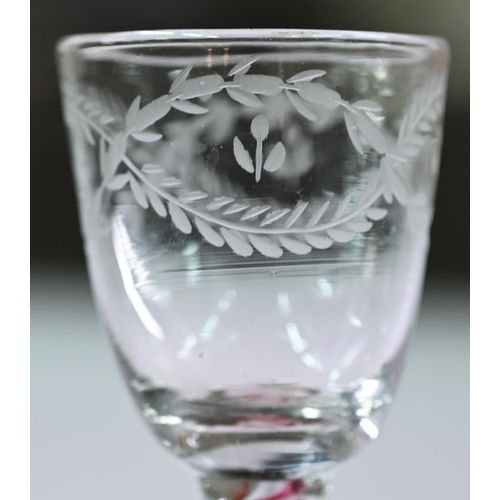 648 - A Georgian cordial glass cut with intertwined foliated guilloches, on red/white opaque triple-twist ... 