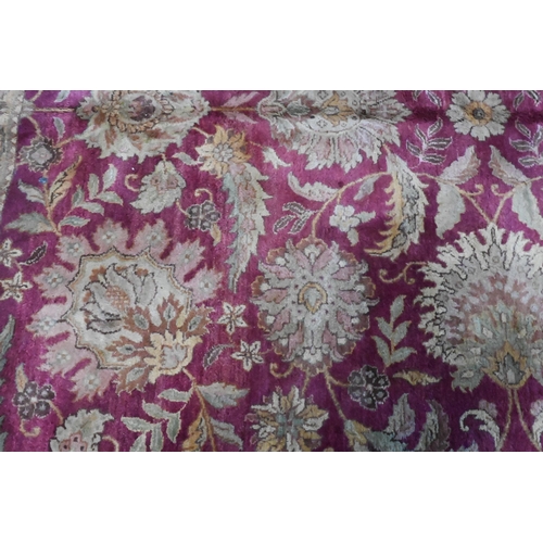 804 - A contemporary Indo-Persian carpet, the wine-red ground with yellow-gold floral and leaf design, 304... 