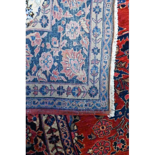 808 - An antique Persian Mohajeran - Sarouk carpet, the dark salmon ground with overall floral design, 353... 