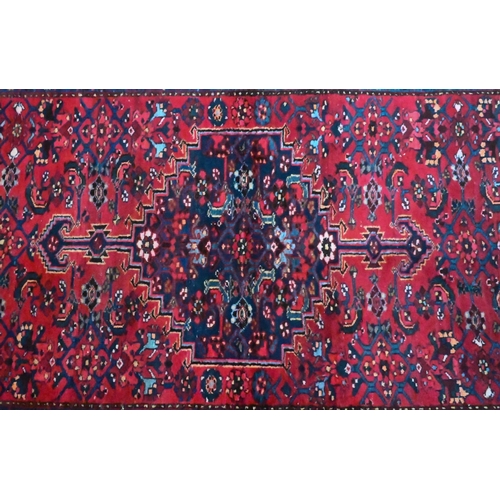 810 - An old Persian Bidjar rug, the red ground centred by a mid-blue ground medallion, 2nd half 20th cent... 