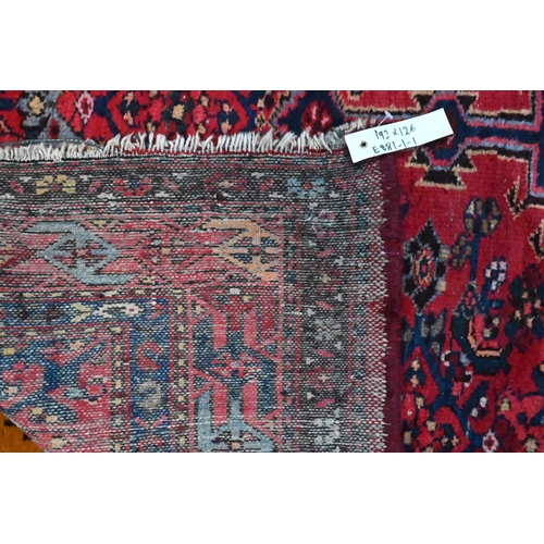 810 - An old Persian Bidjar rug, the red ground centred by a mid-blue ground medallion, 2nd half 20th cent... 