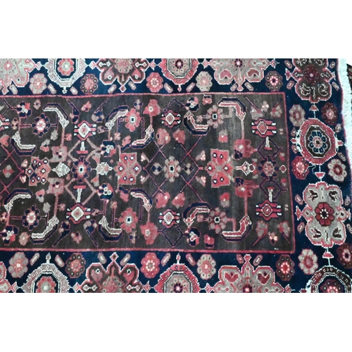 811 - A Persian blue ground Lilihan runner, the repeating geometric design on brown ground, 296 cm x 104 c... 