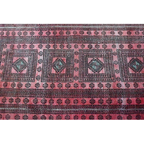 815 - An old Persian soft-red ground rug, 2nd quarter 20th century, 190 cm x 105 cm