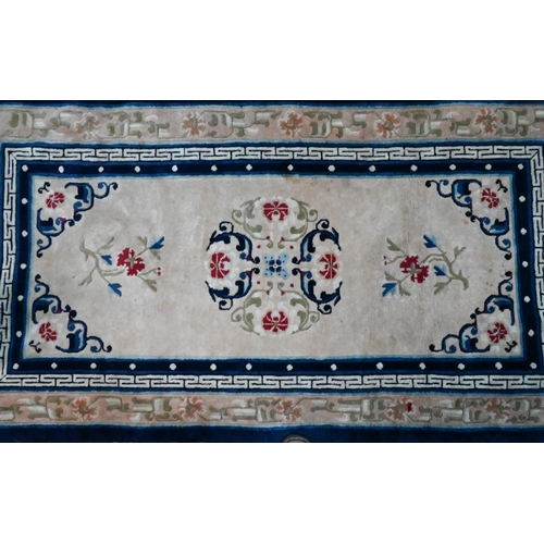 816 - An antique Chinese Peking rug, first quarter 20th century, the camel ground with scattered blue desi... 