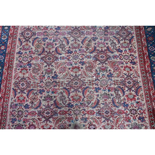 821 - An antique Persian Bakhshayesh carpet, the geometric all-over repeat design on camel ground, 530 cm ... 