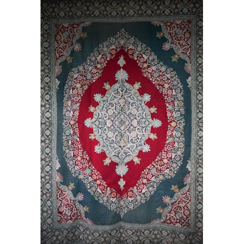 822 - A large antique Kashmir crewel work carpet, first quarter 20th century, the soft red ground with sty... 