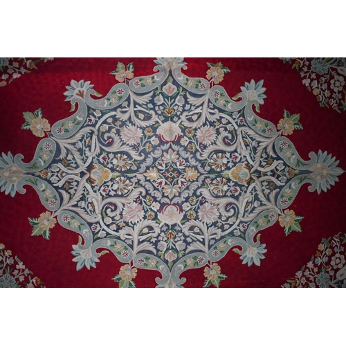 822 - A large antique Kashmir crewel work carpet, first quarter 20th century, the soft red ground with sty... 