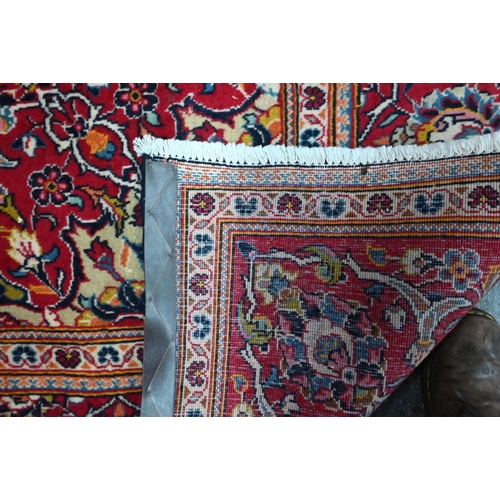 823 - A contemporary central Persian Kashan carpet, the blue and red ground centred by a floral medallion,... 