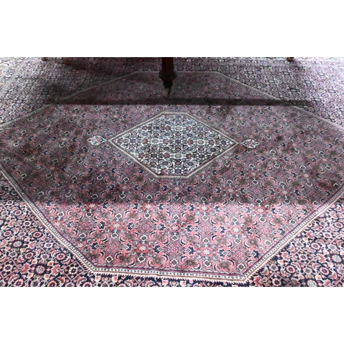 824 - A Persian Bidjar red ground carpet, centred by a diamond floral lozenge, 335 cm x 247 cm