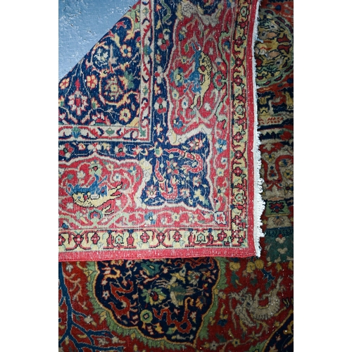 825 - A good fine antique Persian Kashan rug, the rust-red ground centred by a blue ground medallion, the ... 