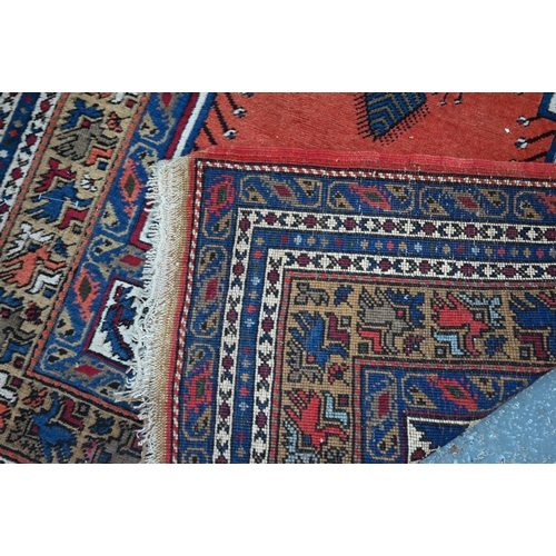 828 - A contemporary Turkish prayer design rug, the coral ground centre panel flanked by stylised floral d... 