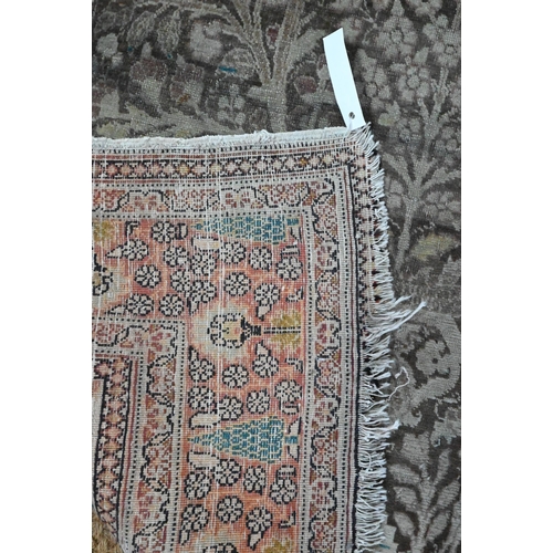 834 - A camel ground Persian Meshed rug, worn, low pile, 166 cm x 121 cm to/with a silk Indo-Persian kasha... 