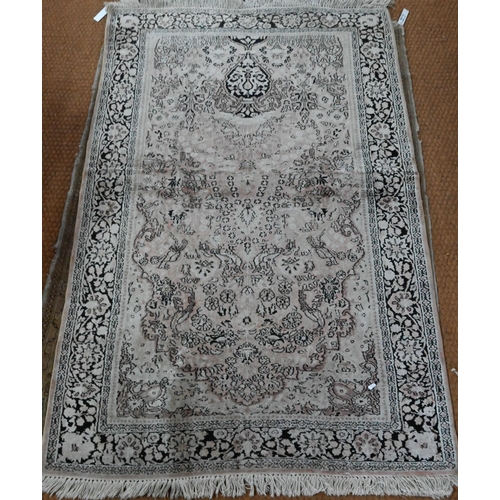 834 - A camel ground Persian Meshed rug, worn, low pile, 166 cm x 121 cm to/with a silk Indo-Persian kasha... 