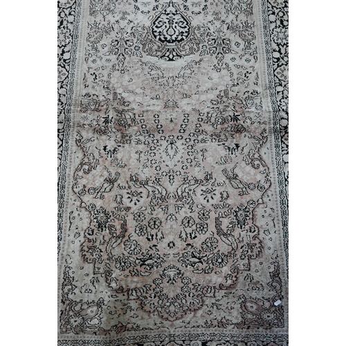 834 - A camel ground Persian Meshed rug, worn, low pile, 166 cm x 121 cm to/with a silk Indo-Persian kasha... 