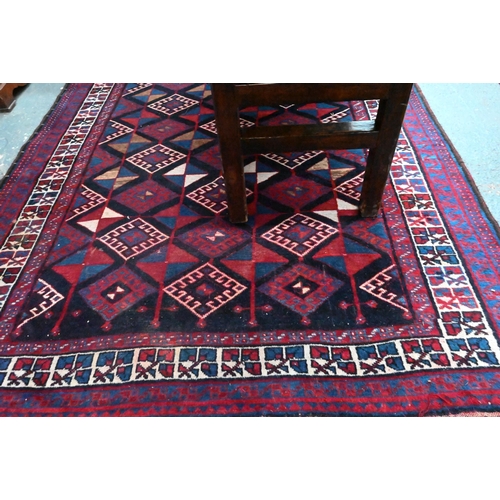 837 - A Persian blue/red ground geometric design rug, 258 cm x 166 cm