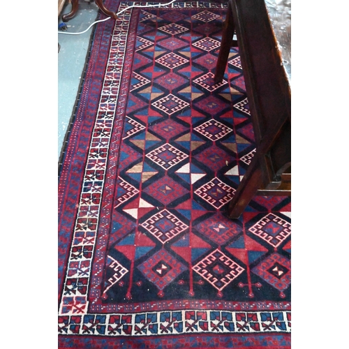 837 - A Persian blue/red ground geometric design rug, 258 cm x 166 cm