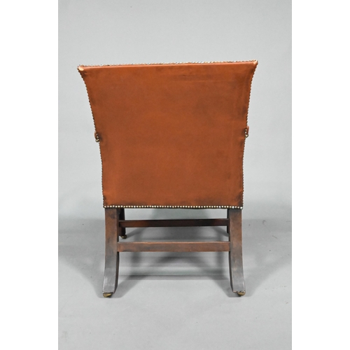 852 - An antique mahogany Gainsborough style library elbow chair, with studded brown leather upholstery, r... 